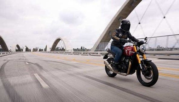 a person on a motorcycle on a bridge